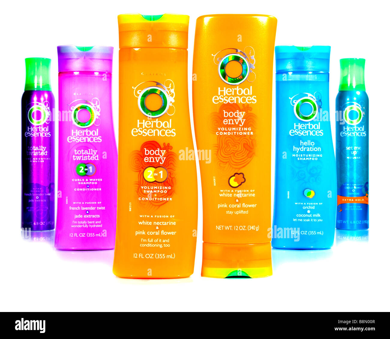 A colorful display of Herbal Essences products: mousse, conditioner, and shampoo. Stock Photo
