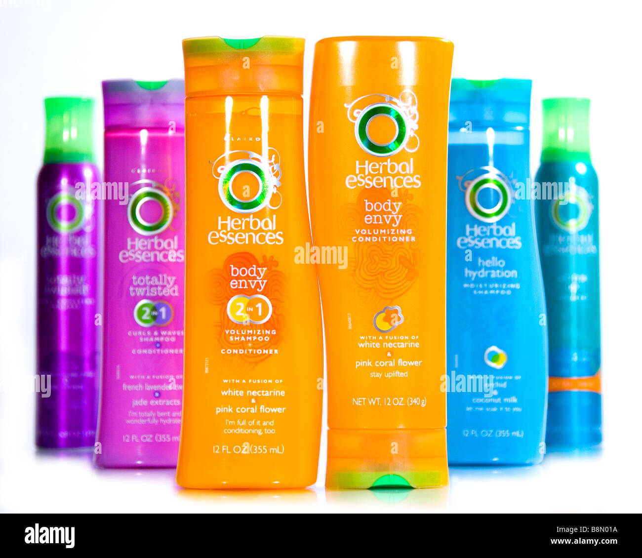 A colorful display of Herbal Essences products: mousse, conditioner, and shampoo. Stock Photo