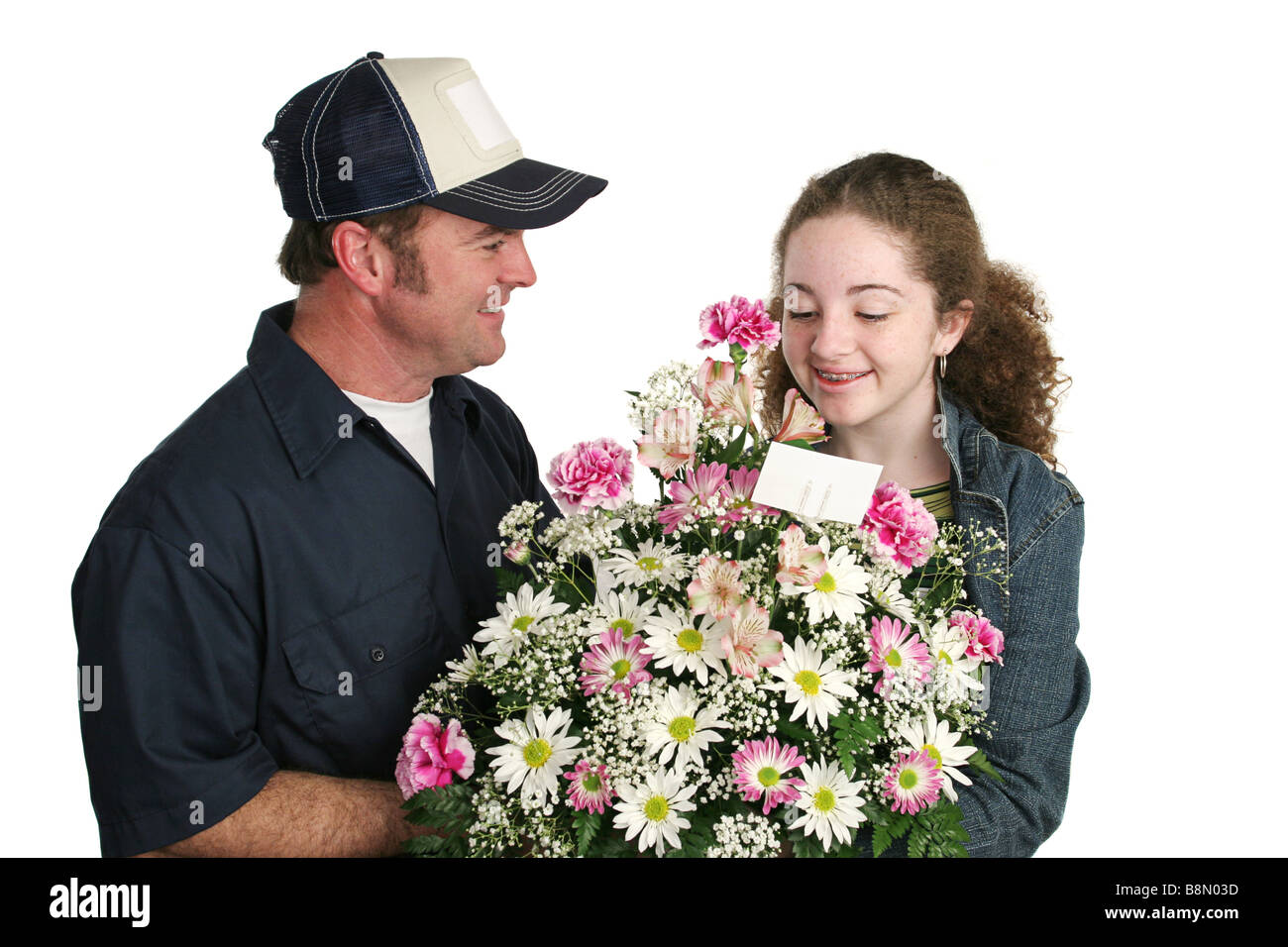 A cute teen girl receiving flowers unexpectedly Isolated Stock Photo