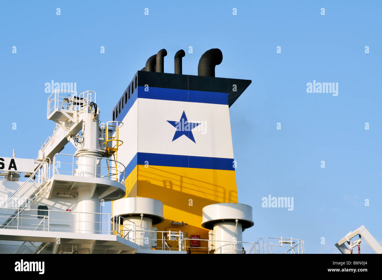 Smokestack on a Greek ship with Greek star emblem against [clear blue sky] Stock Photo