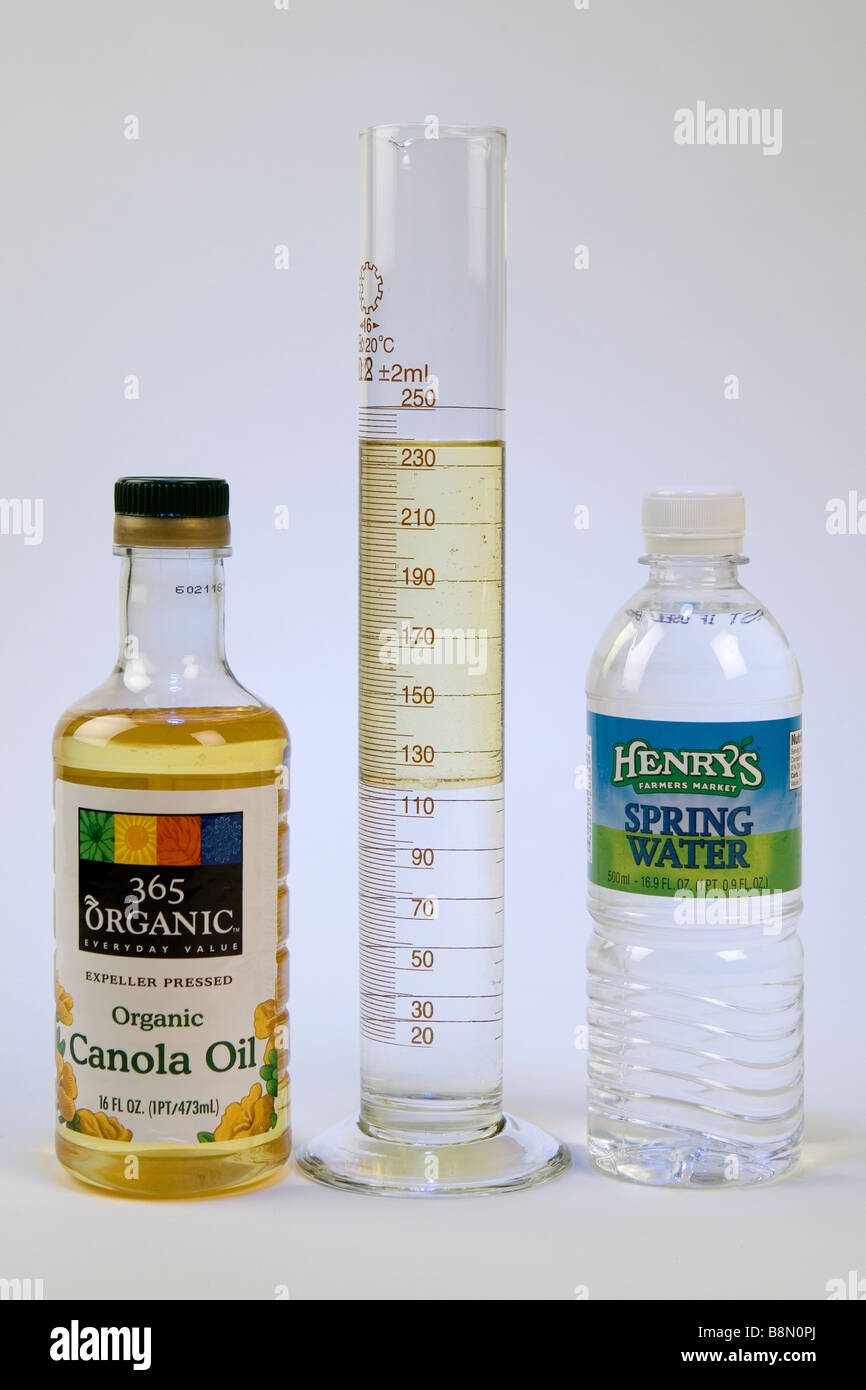 Because it is less dense, canola oil floats on water Stock Photo