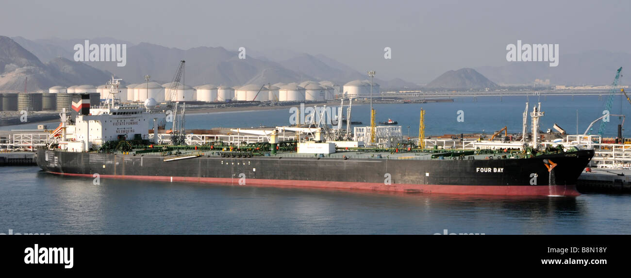 Fujairah port on Gulf of Oman oil tanker ship Four Bay alongside refinery and coastline storage facilities Emirate of Fujairah UAE Middle East Asia Stock Photo