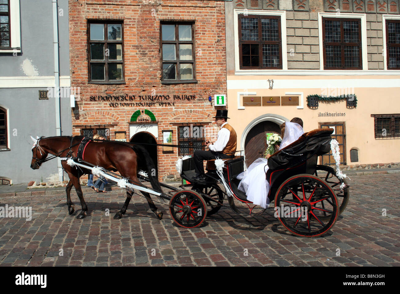Horse and Cart with Bride and Groom at Wedding in Town Hall Square in Kaunas in Lithuania Stock Photo