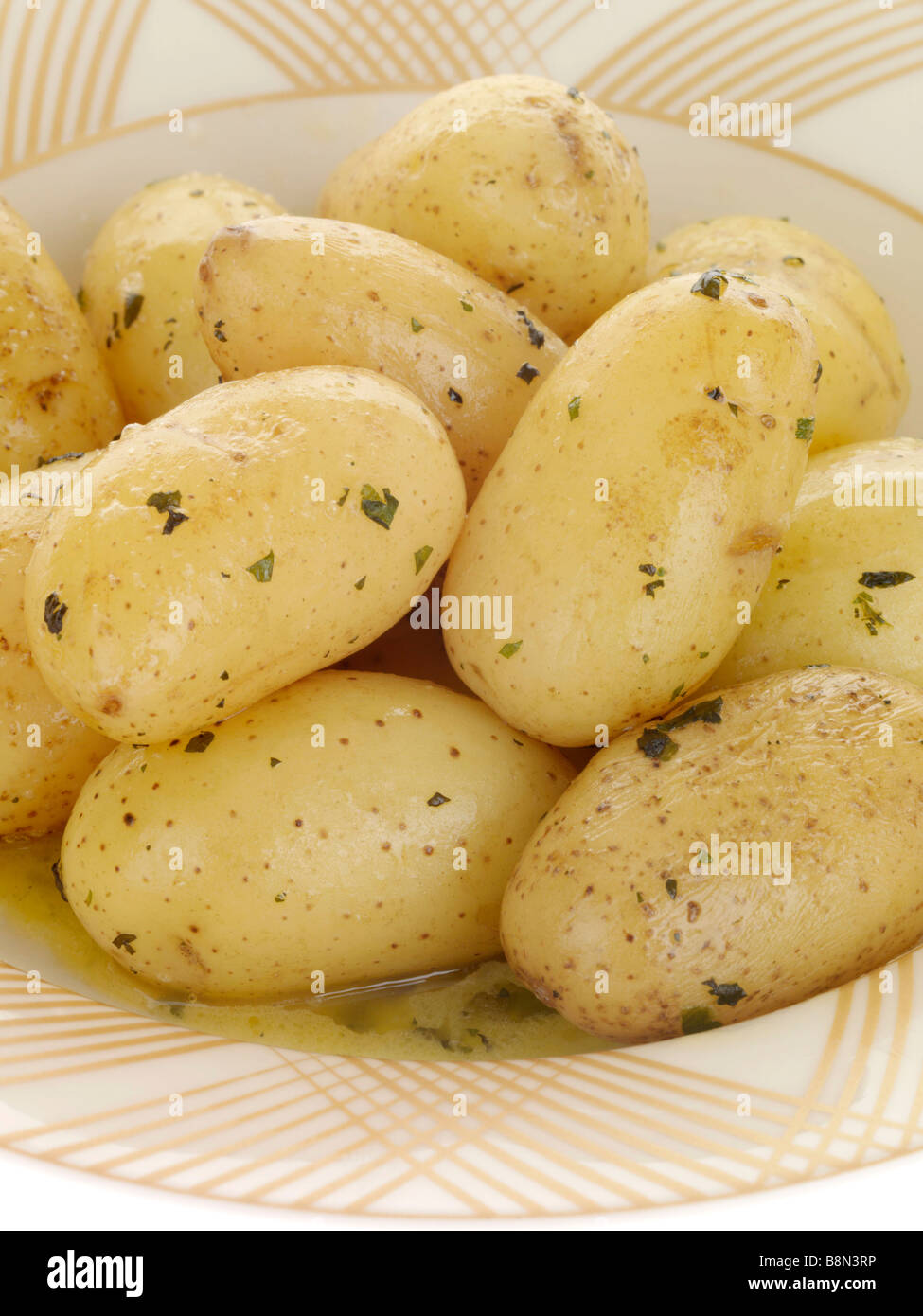 Fresh Boiled New Potatoes With Mint And Butter Isolated Against A White