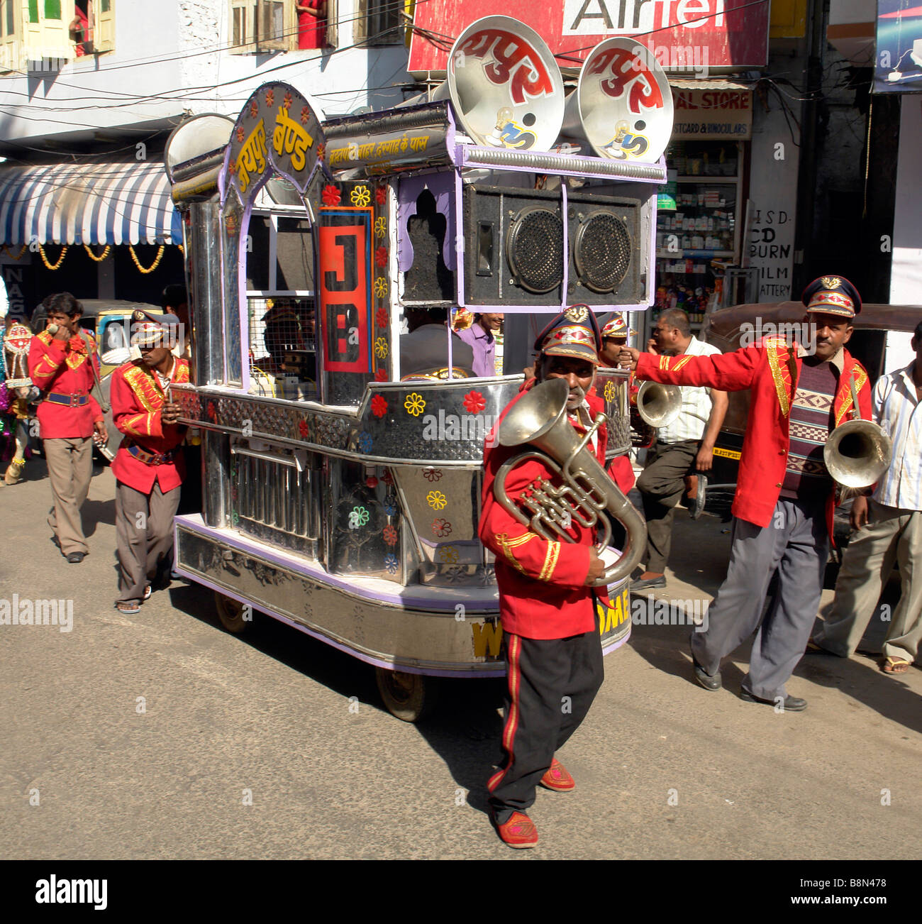 traditional indian band and public address cart or trailer being pulled  through the streets of udaipur during a puja ceremony Stock Photo - Alamy