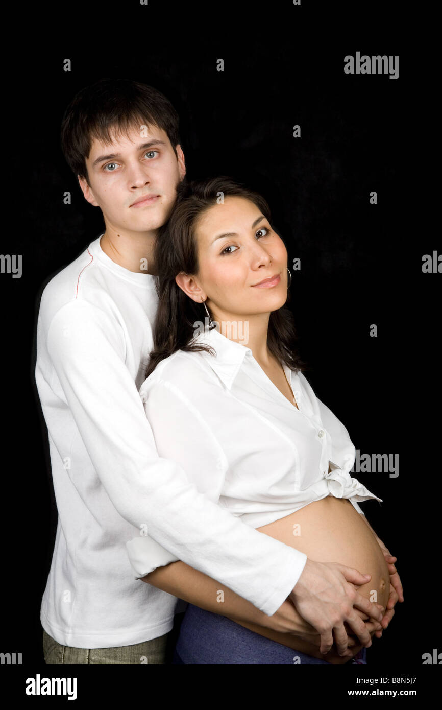 Husband hugging his pregnant wife isolated on black Stock Photo - Alamy