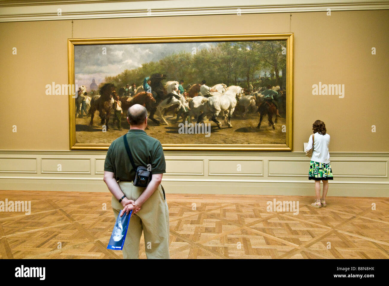 Visitors viewing a painting at the Metropolitan Museum of Art Stock Photo