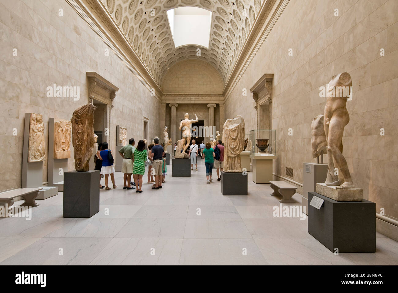 Visitor viewing an exhibition of classical sculptures at the