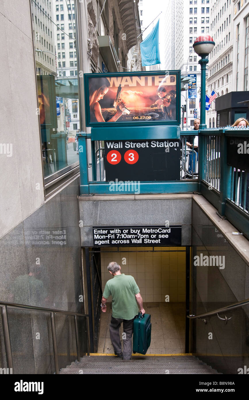 Man descending the steps to the Wall Street subway station Stock Photo