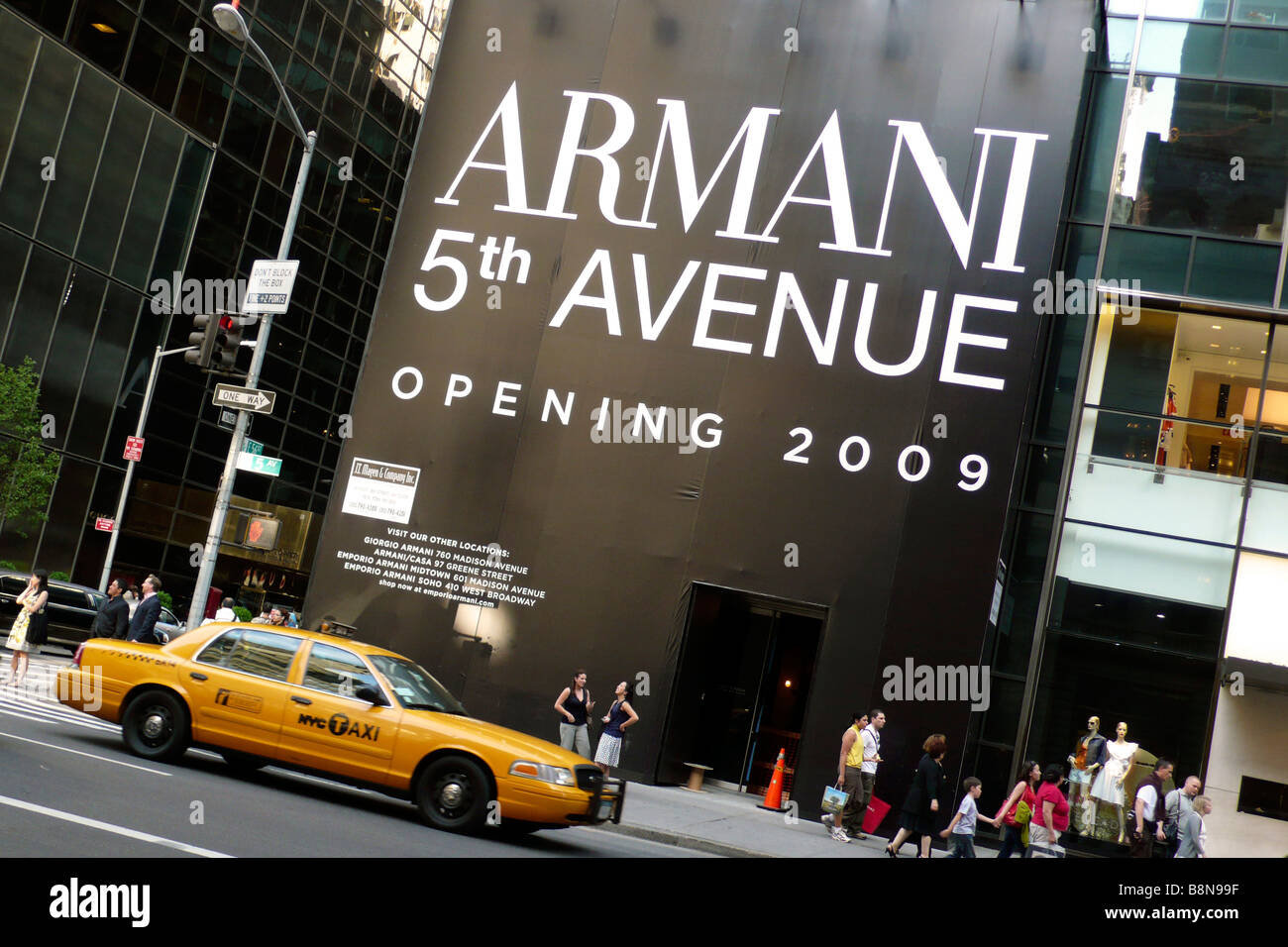 Yellow taxi cab outside the site of new Armani store on 5th avenue Stock Photo