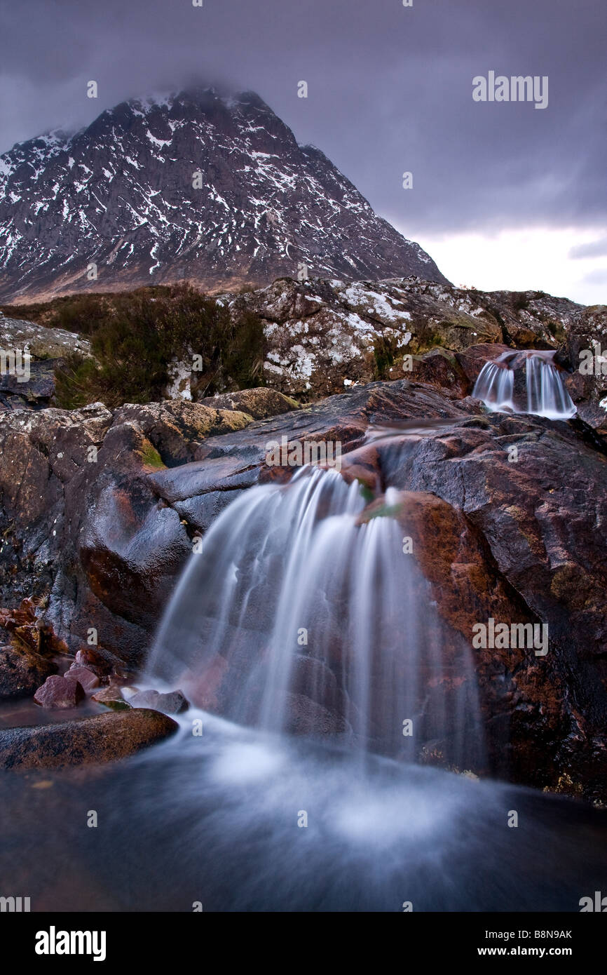 Winter River Scene, Snow Capped Buachaille Etive Mor with Waterfall at Dawn, Scottish Highlands, Scotland. U.K. Stock Photo