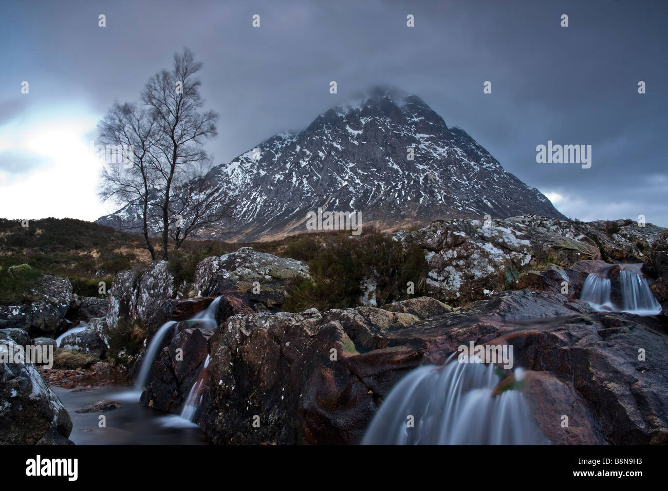 Winter River Scene, Snow Capped Buachaille Etive Mor with Waterfall at Dawn, Scottish Highlands, Scotland. U.K. Stock Photo