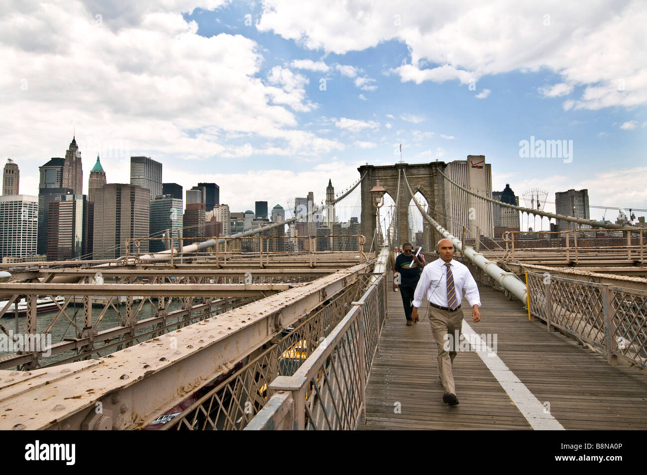 Smartly dressed pedestrian crossing the Brooklyn bridge Stock Photo