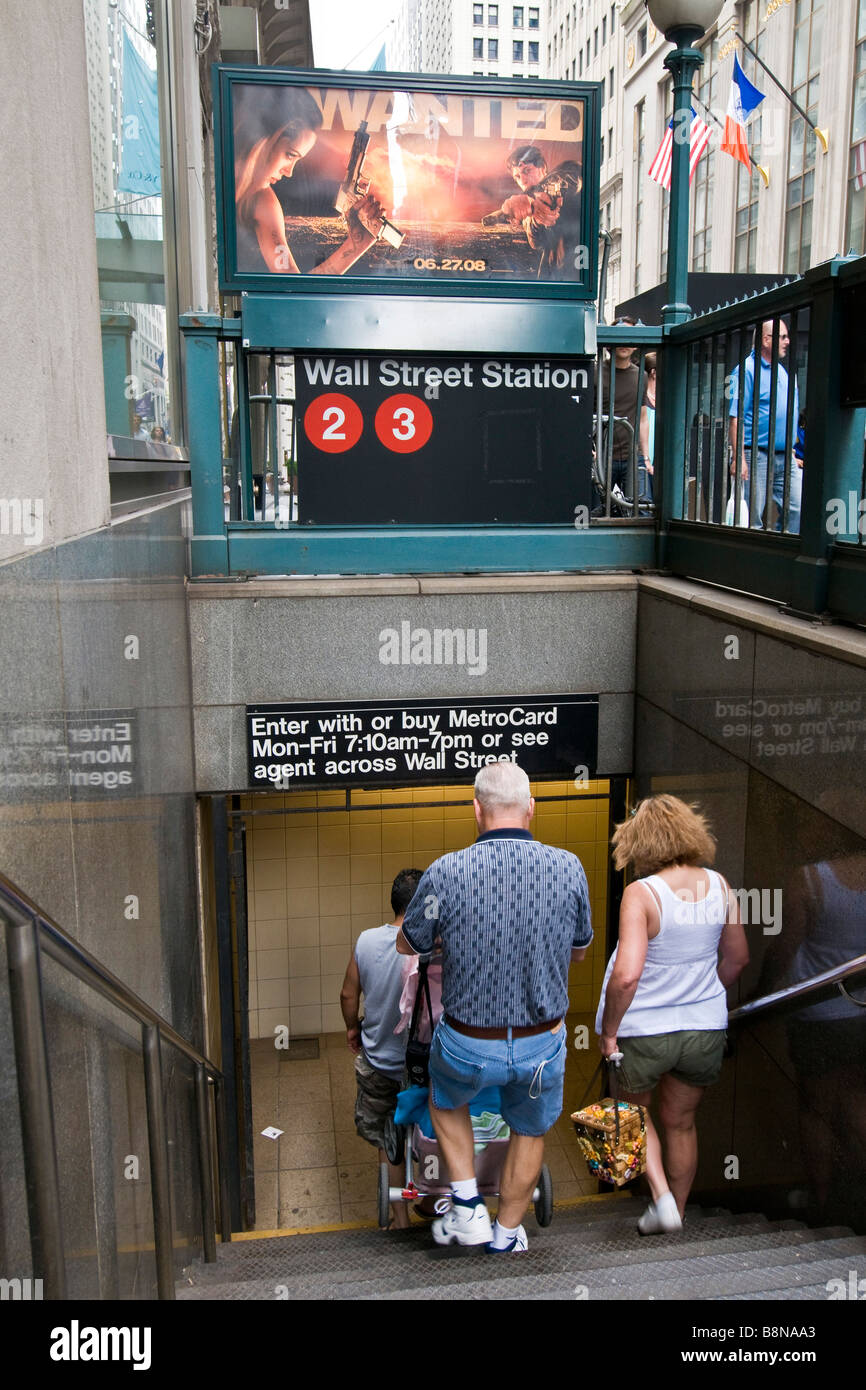 People descending the steps to the Wall Street subway station Stock Photo