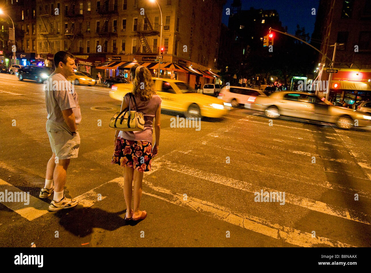 Pedestrians walking along 93rd street at night Stock Photo