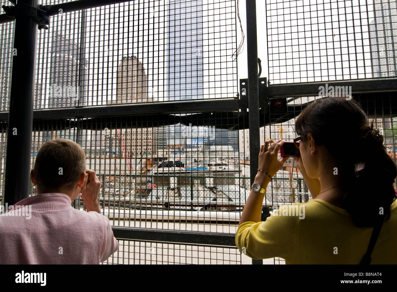 Tourists taking photographs through wire mesh of the site of ground zero Stock Photo