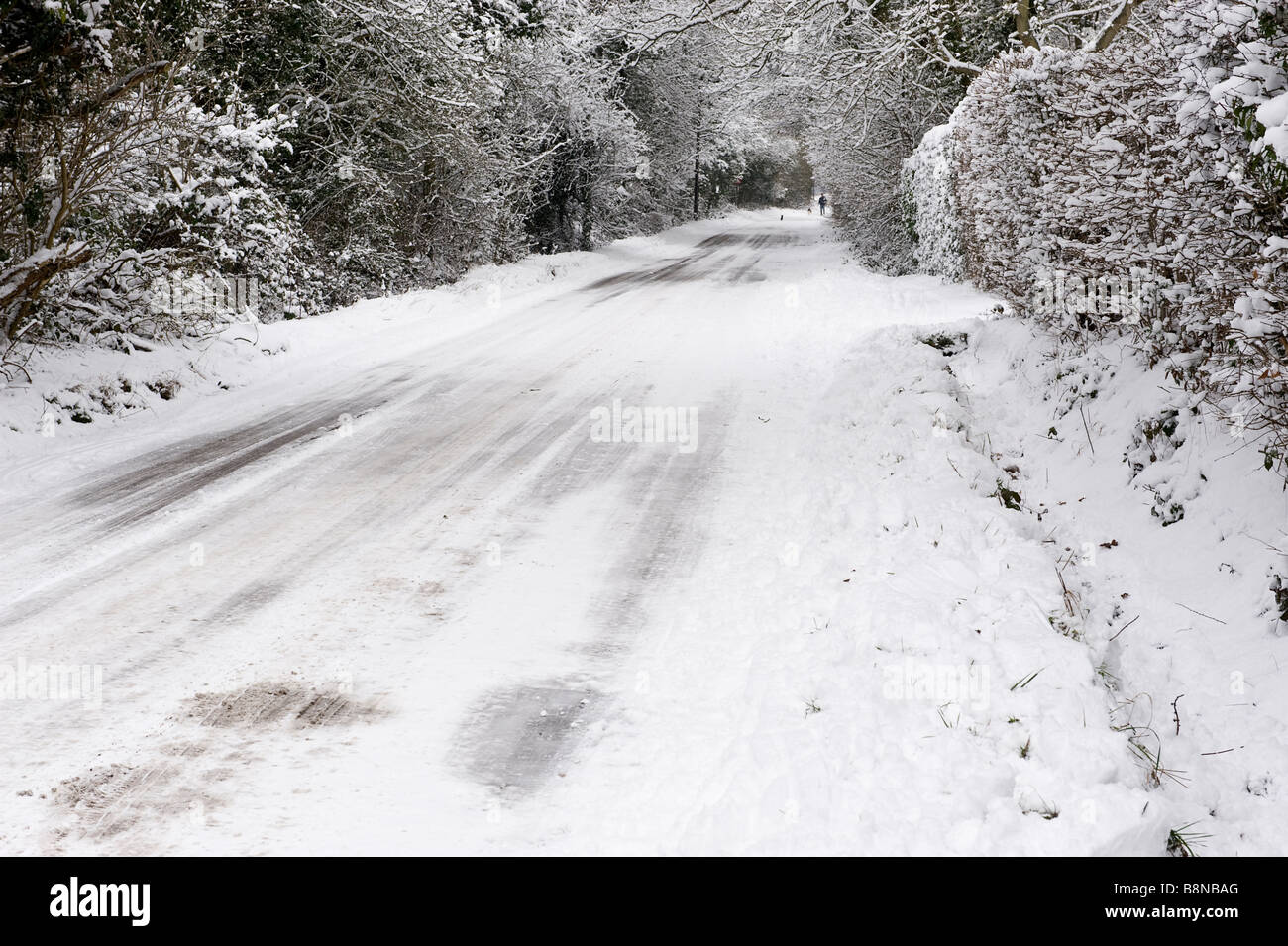 A snow covered empty rural country road in a UK Winter Stock Photo