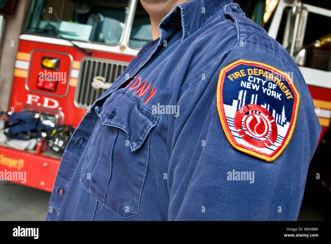 Close up of New York city fire department badge on fireman's denim jacket  taken in front of fire truck Stock Photo - Alamy