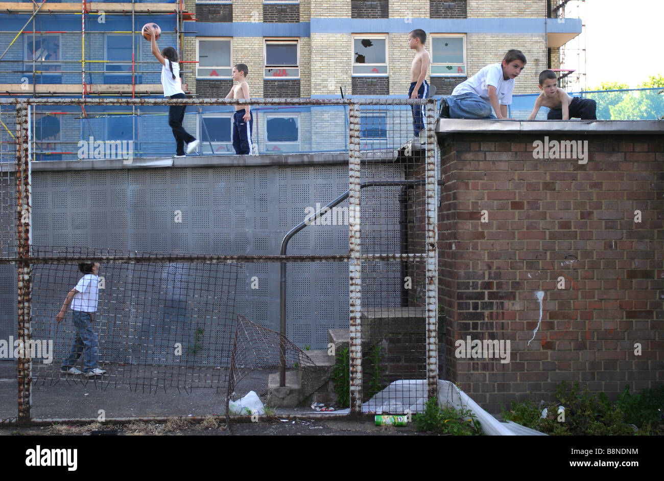 Children playing on roof tops next to derelict housing. Stock Photo