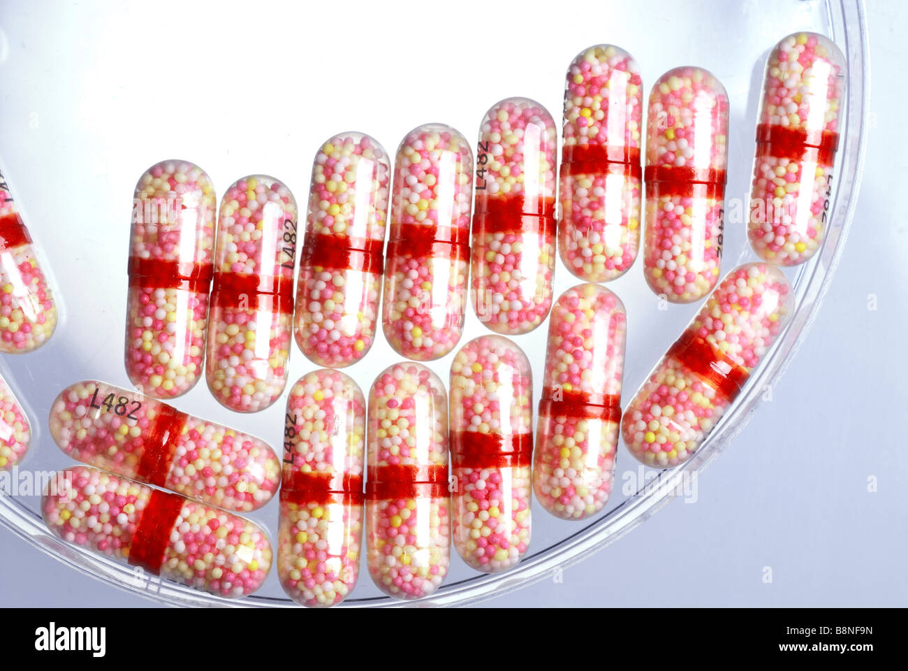 Pharmaceutical drug capsules containing time release cold medicine mini-pills. Stock Photo