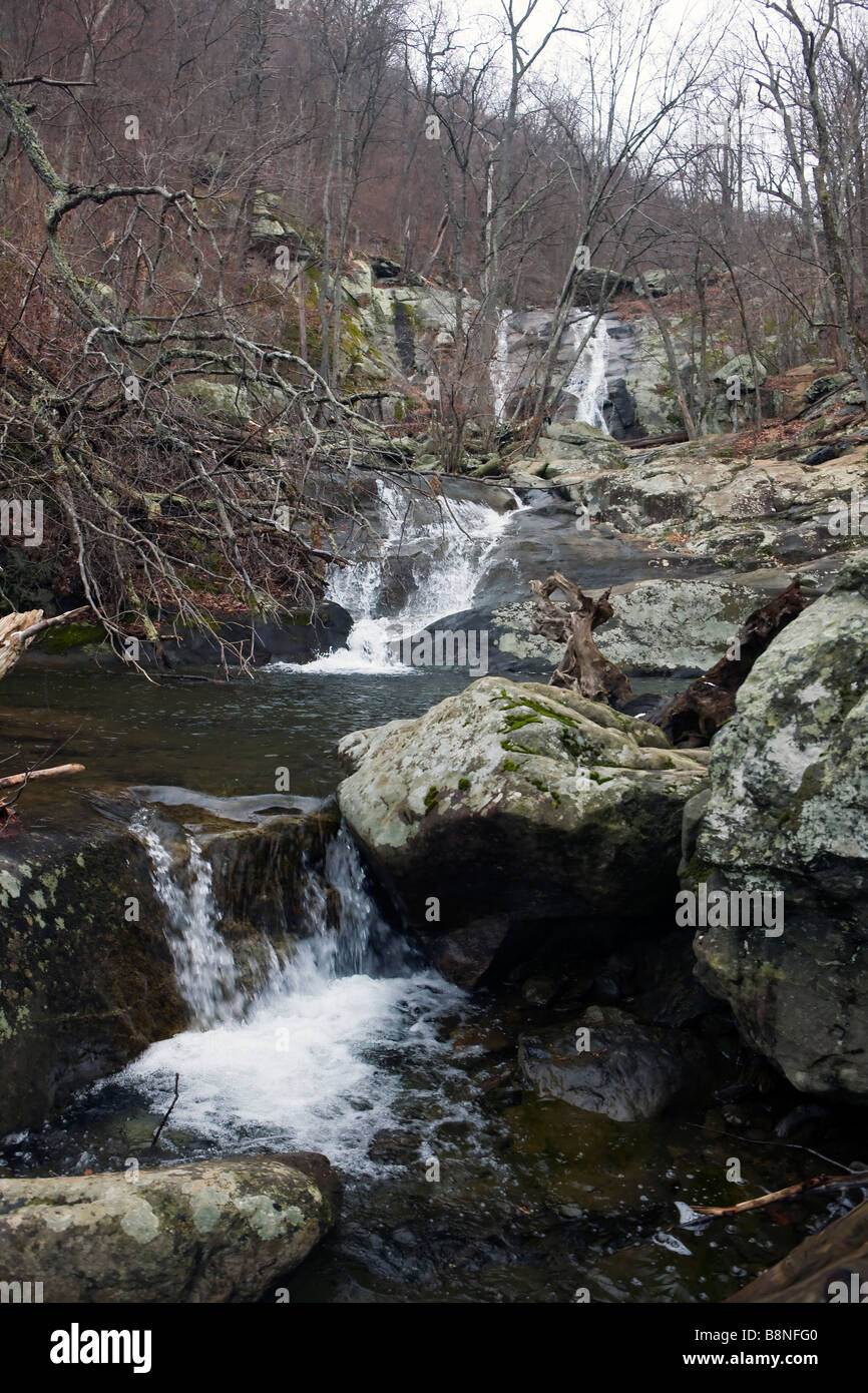 Water falls down rocks along a river at Lower White Oak Falls Whiteoak Canyon Trail and Falls Shenandoah National Park Virginia Stock Photo