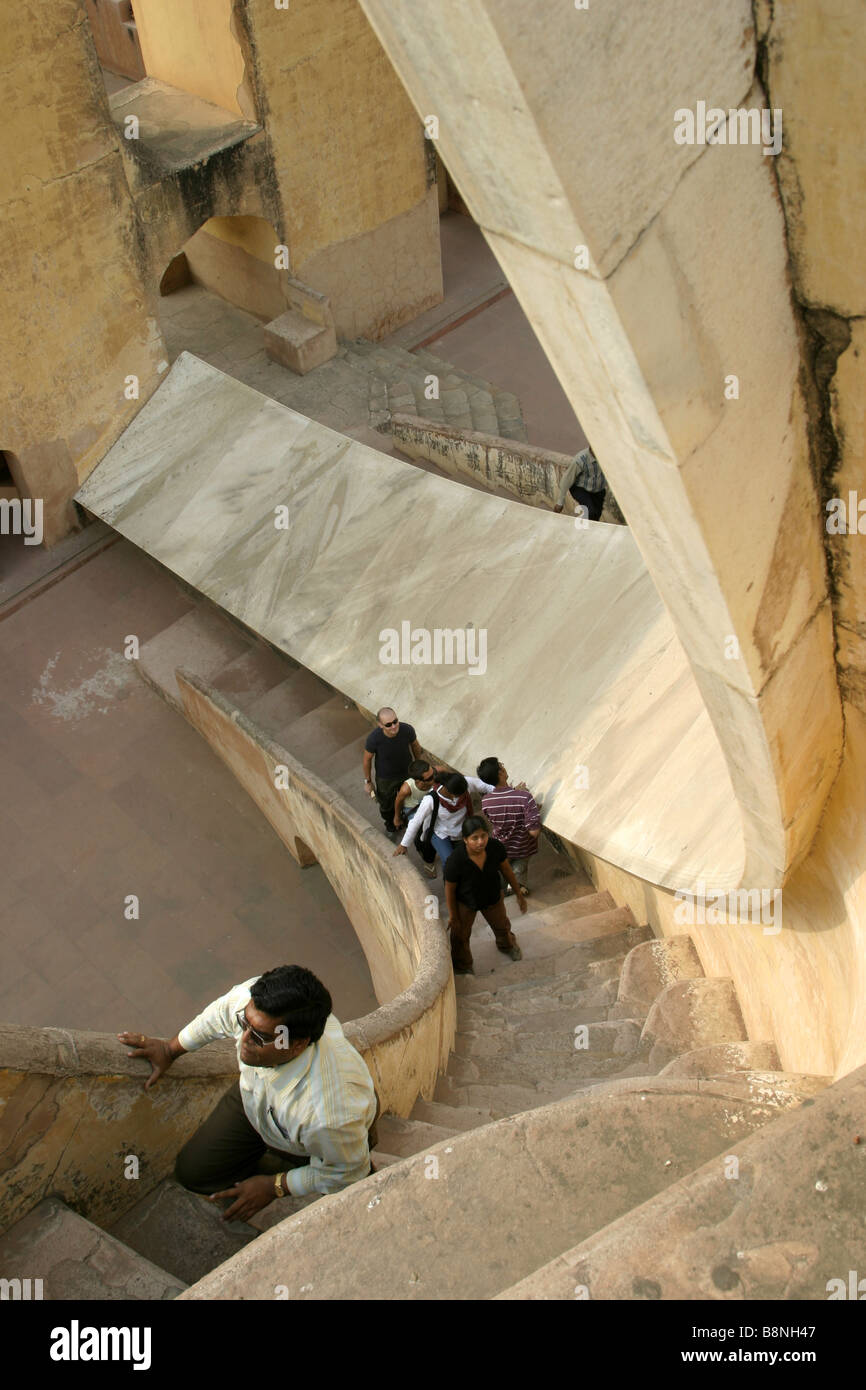 People climbing the giant sundial Samrat Jantar in the Jantar Mantar observatory in Jaipur India Stock Photo