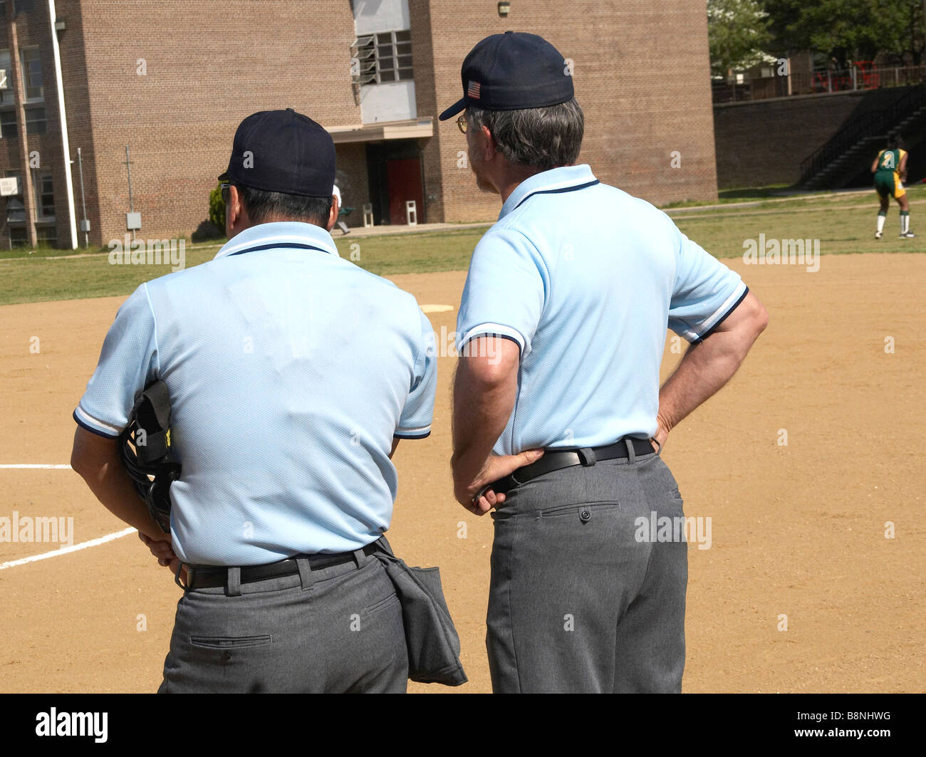 2 umpires at a high school softball game Stock Photo