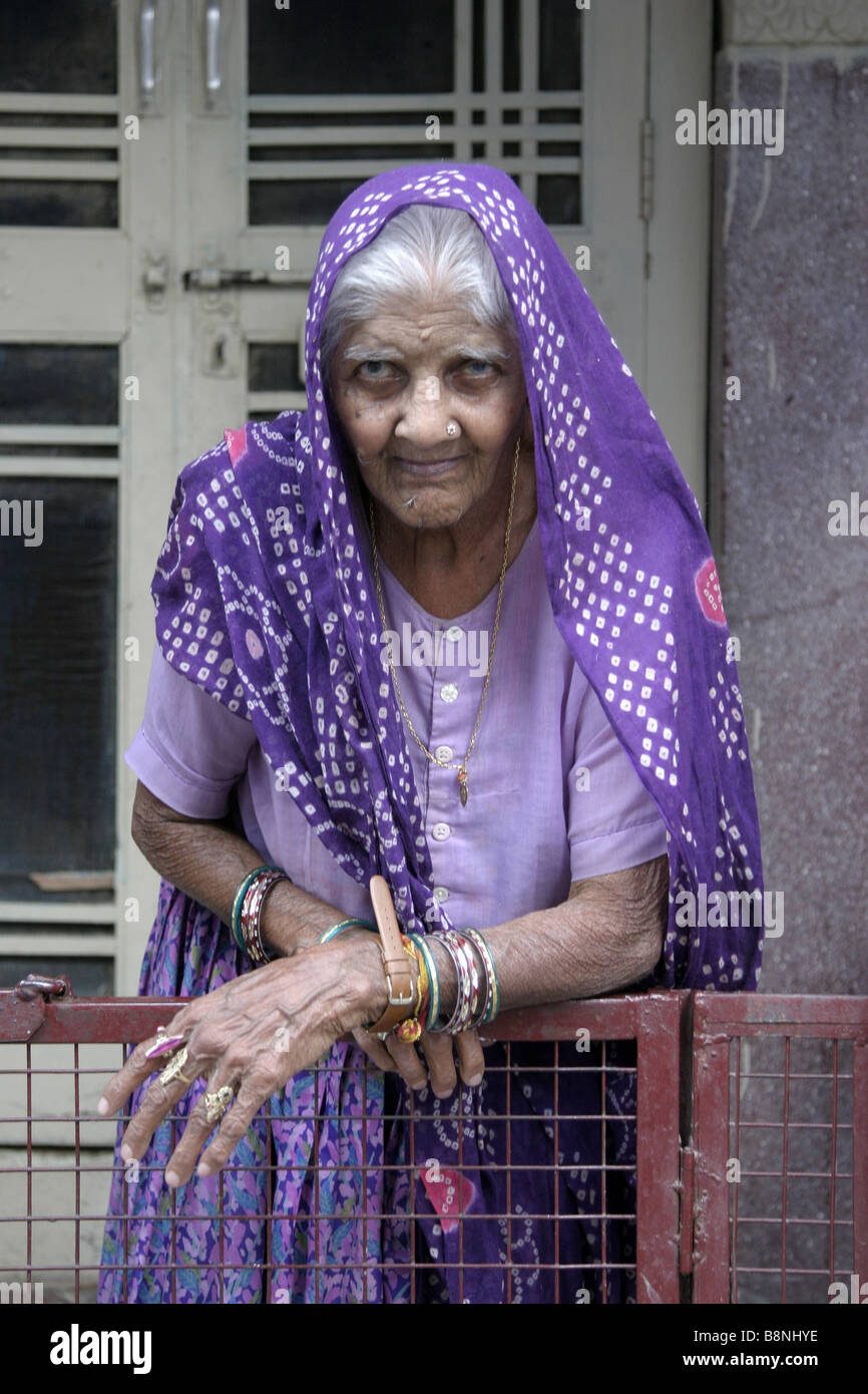 Old indian woman with purple head scarf Stock Photo