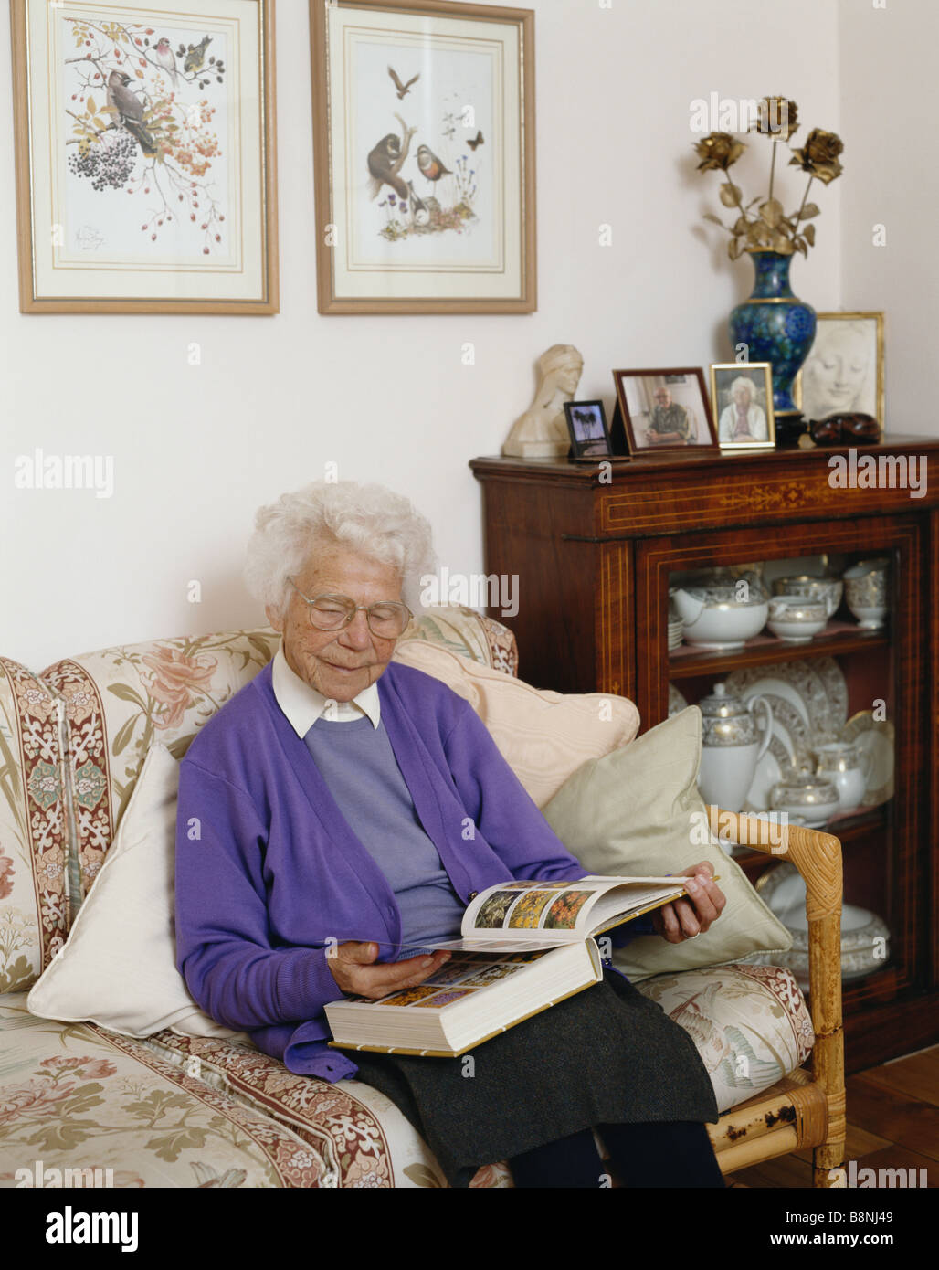 Elderly woman reading book at home Stock Photo