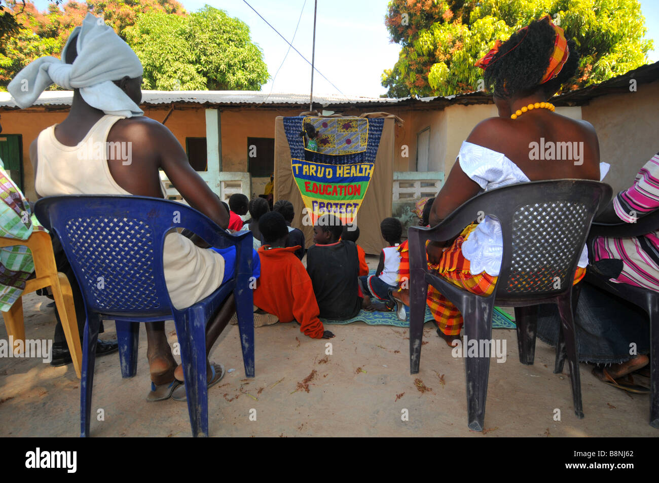 Villagers watch a health education puppet show, The Gambia, West Africa