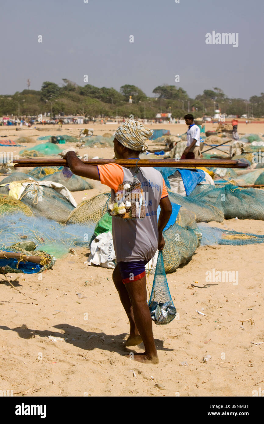 India Tamil Nadu Chennai beach fisherman walking home with meagre catch Stock Photo