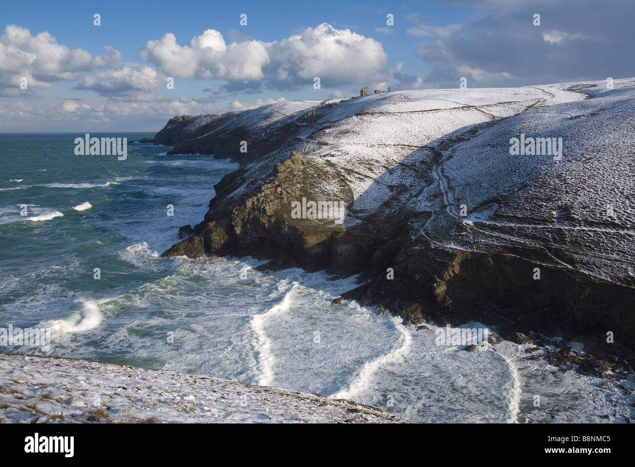 Chapel Porth in Cornwall in the snow with Wheal Coates mine and Towanroath engine house in the background Stock Photo