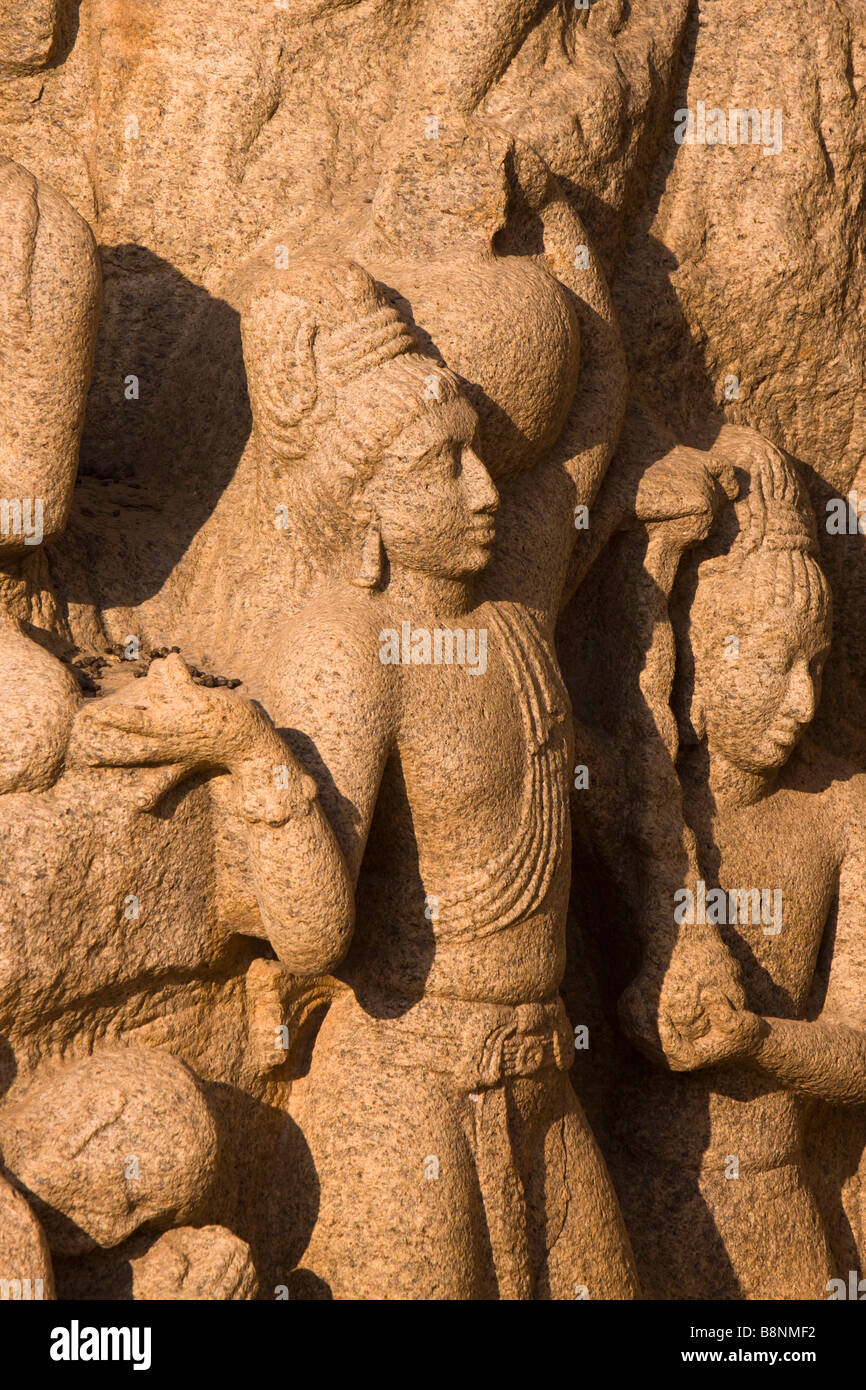 India Tamil Nadu Mamallapuram Arjunas Penance Hindu rock carving man carrying water in pot Stock Photo