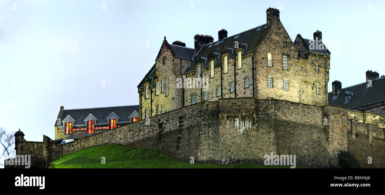 Edinburgh Castle illuminated at nightfall in winter from the north west Stock Photo