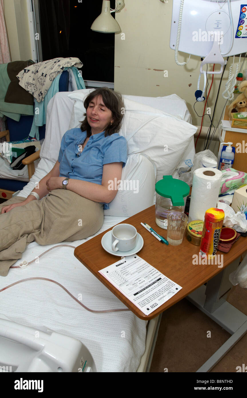 Woman lying on NHS hospital bed of having had an amputation of the left
