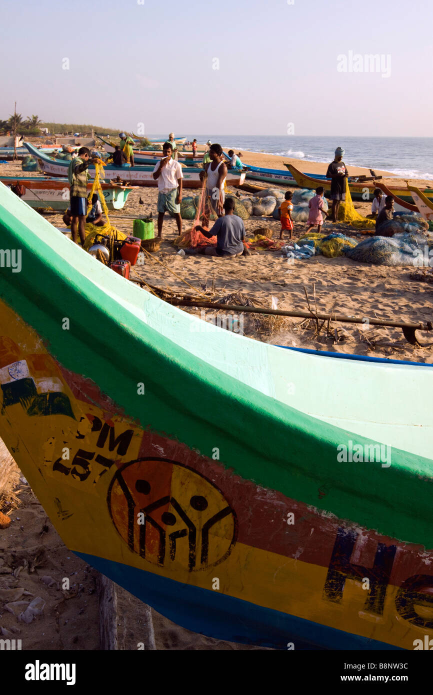 India Tamil Nadu Mamallapuram fishing village fishermen tending nets amongst tsunami relief boats Stock Photo