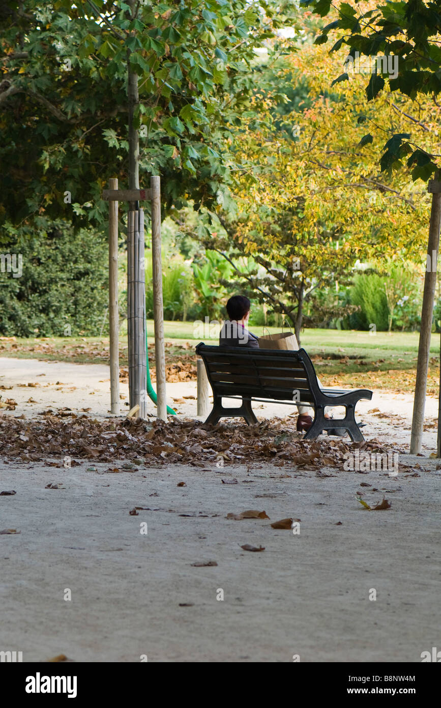 France, Paris, man sitting on park bench Stock Photo
