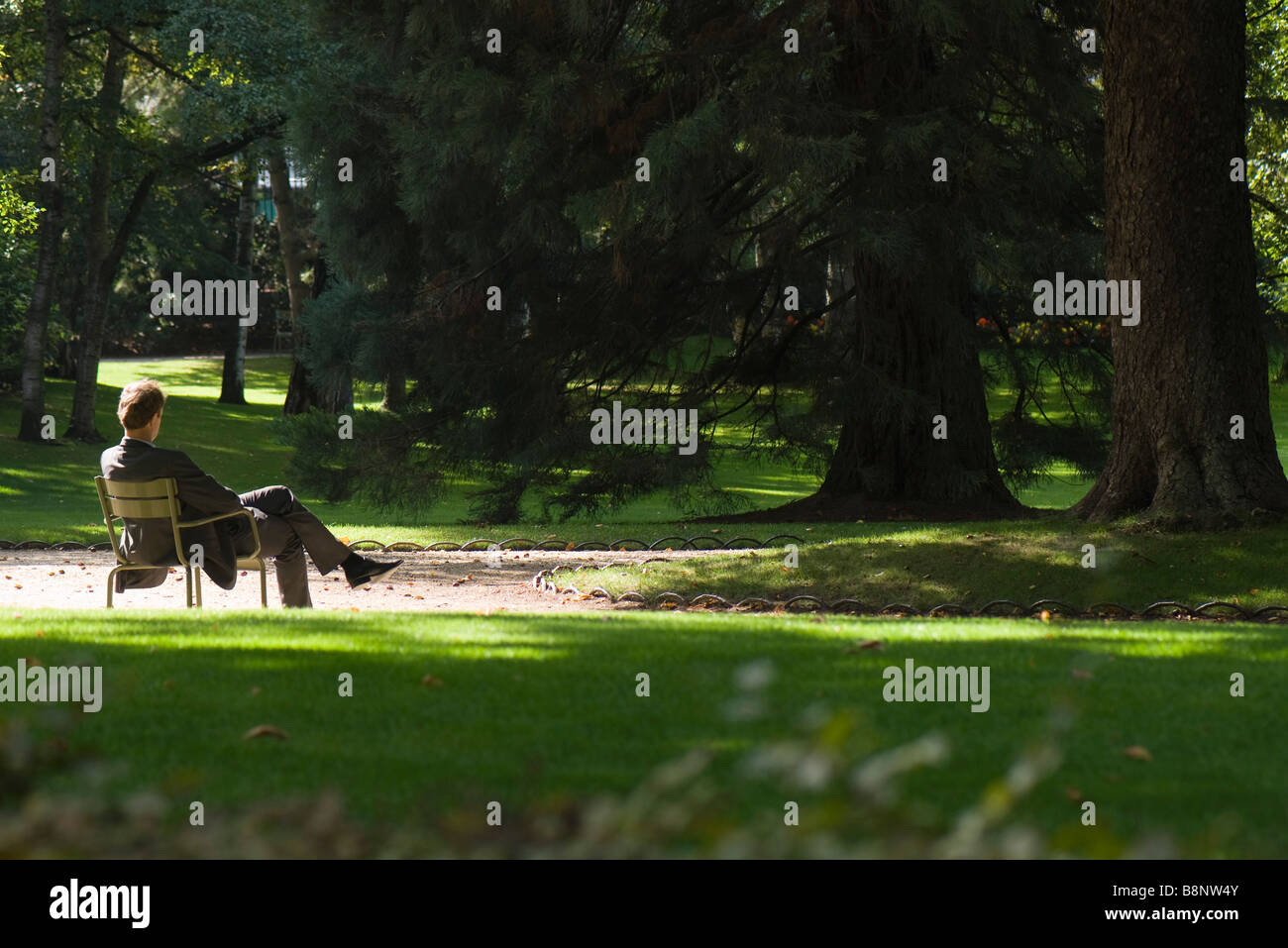 Man alone sitting rear view hi-res stock photography and images - Alamy