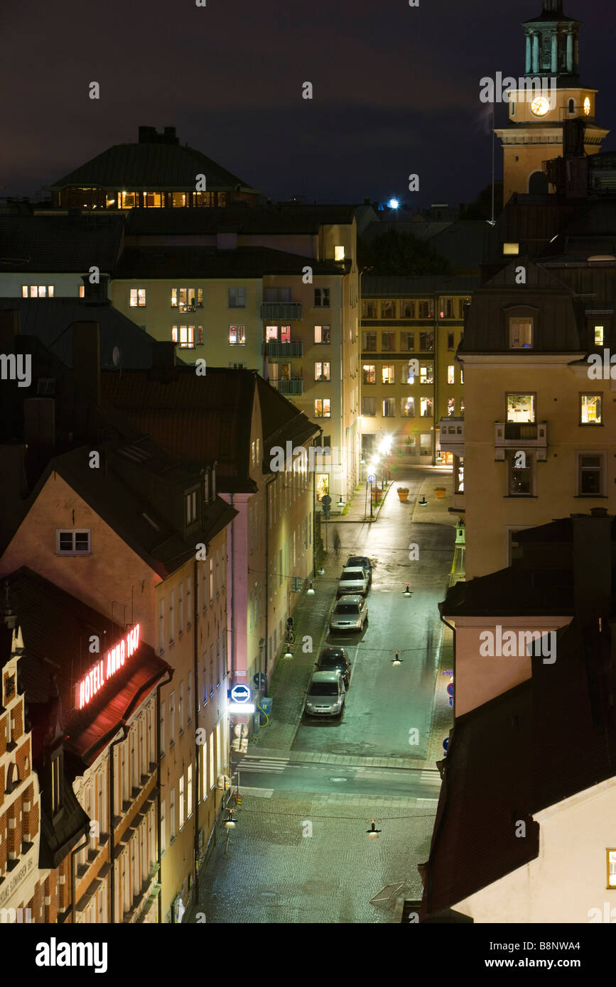 Sweden, Stockholm, apartment buildings and street at night Stock Photo