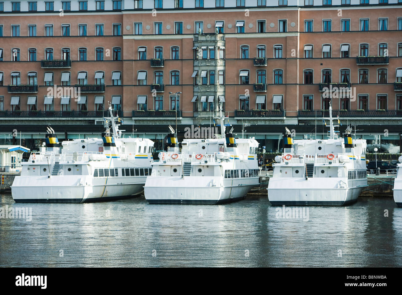 Sweden, Stockholm, yachts docked in canal front of apartment buildings Stock Photo