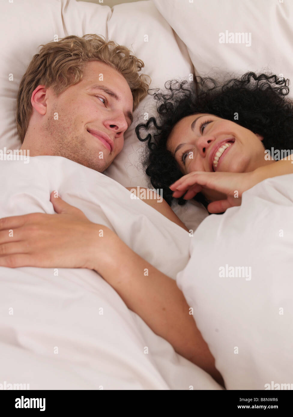 young couple in bed Stock Photo