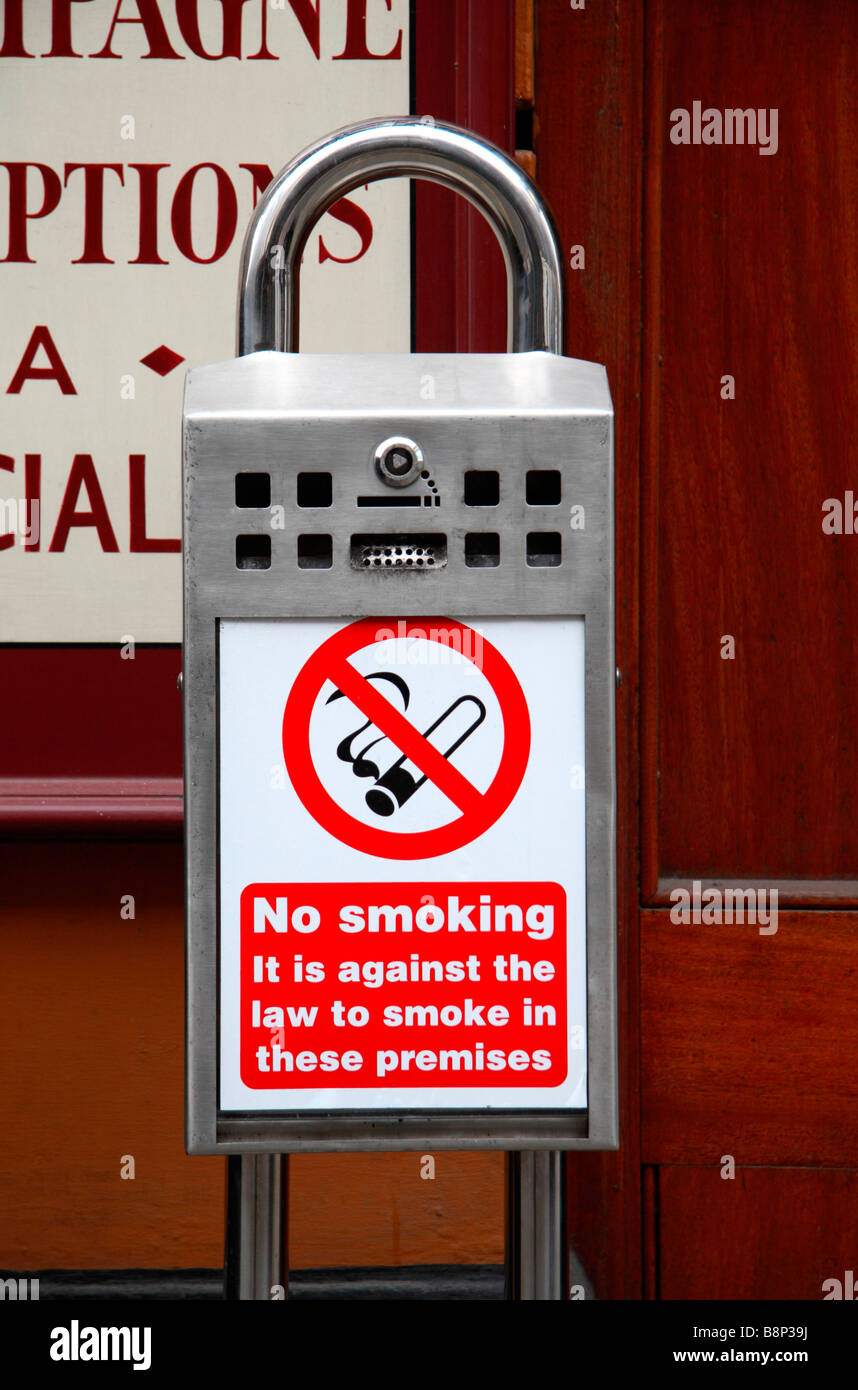 A No Smoking sign on a public cigarette ashtray outside a public house in London. Feb 2009. Stock Photo