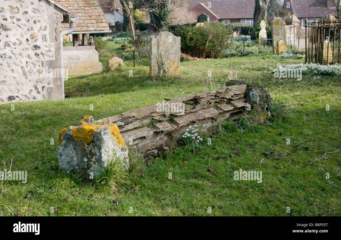 Remains of Medieval stocks in the churchyard at Piddinghoe, East Sussex. Stock Photo