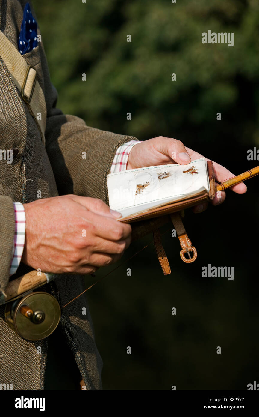 Wales Wrexham A trout fisherman selects his fly to fish on the River