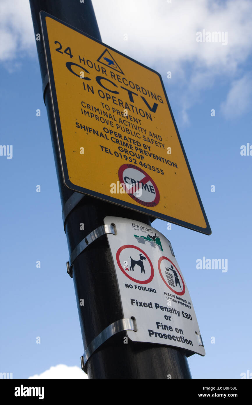 A lamp post mounted warning sign, giving notice that the area is being watched by CCTV Stock Photo
