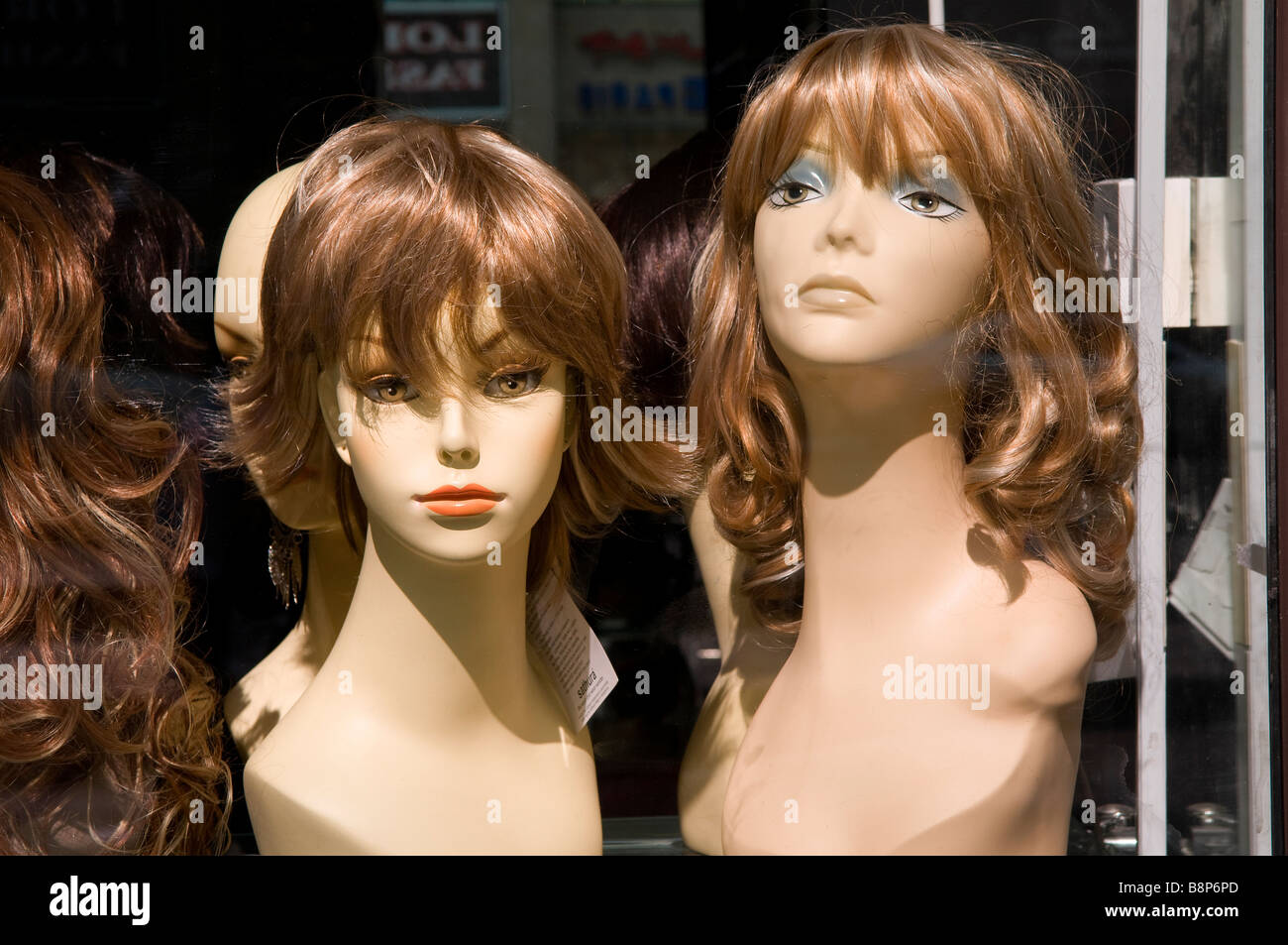 dubai shop window with female wig display Stock Photo Alamy