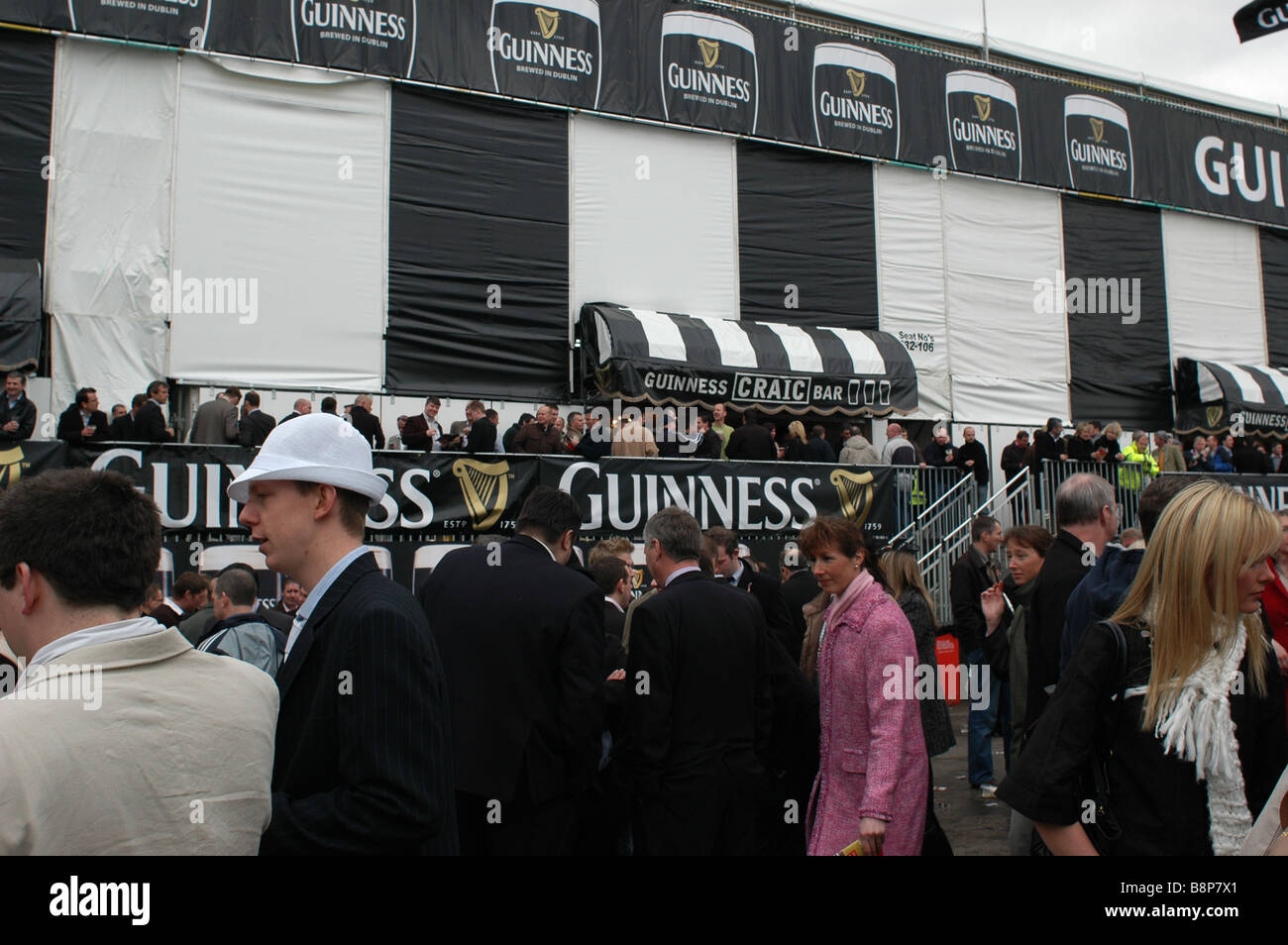 Cheltenham Gold Cup Guinness Village, crowded fans drinking amongst the flags Craic Bar Stock Photo