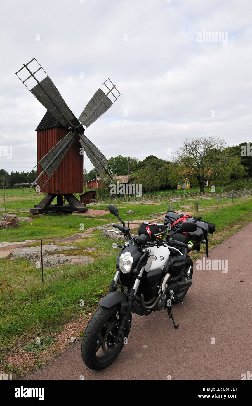 Windmill and motorbike near village Skarpnatoe Aland Islands Finland September 2008 Stock Photo
