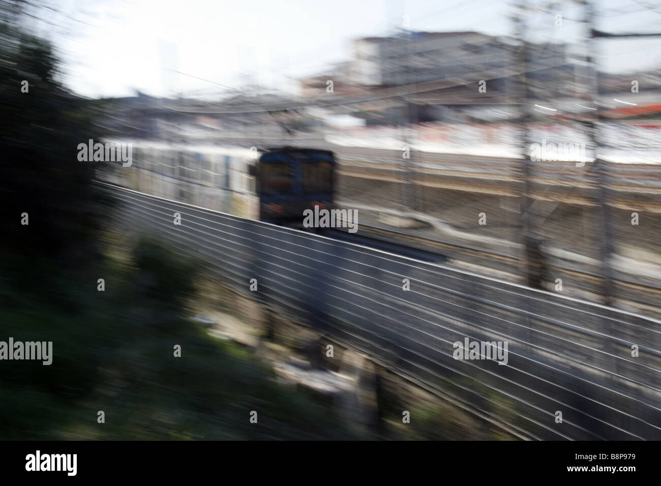 fast metro train covered with graffiti art on tracks in city Stock Photo