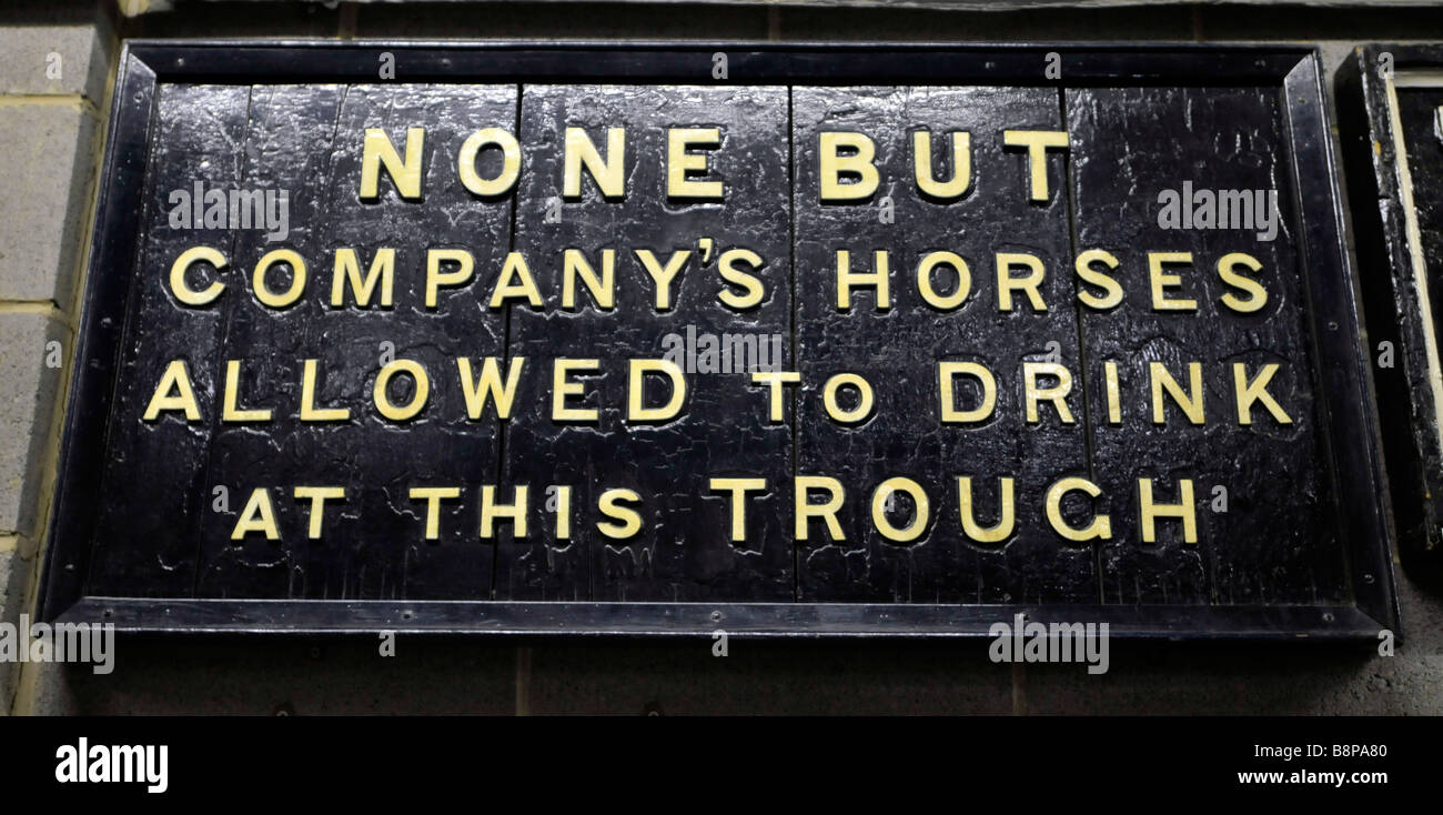 None but company's horses allowed to drink at this trough sign Stock Photo